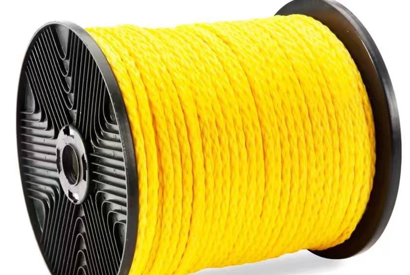 A spool of yellow twisted polyethylene rope on a black plastic reel, photographed against a plain white background.